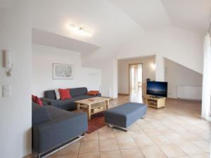 ein Wohnzimmer mit einem Sofa und einem TV in der Unterkunft Haus Hartmann, Ferienwohnungen Sonnenseite in Wasserburg
