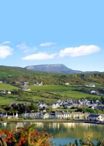 a small town with houses and a body of water at Arnolds Hotel in Dunfanaghy