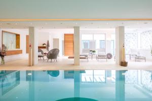 a house with a swimming pool and a living room at Landhaus am Stein in Bad Wiessee