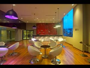 a room with a table and chairs and a kitchen at Keys Select by Lemon Tree Hotels, Visakhapatnam in Visakhapatnam