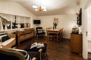 a living room with a table and a dining room at Sea Side Cottages in Eyrarbakki