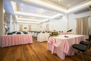 a banquet hall with tables and chairs with pink tablecloths at Nisasiri Boutique Resort in Laem Sing +66 photos