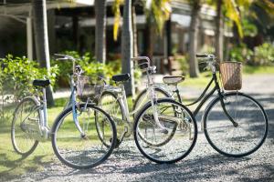 three bikes parked next to each other on a street at Nisasiri Boutique Resort in Laem Sing