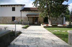 a walkway in front of a house with a building at Nostra Signora Del Lago in Ronciglione