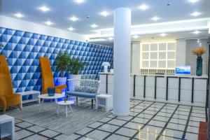 
a living room filled with furniture and a blue wall at Terrace Mar Suite Hotel in Funchal
