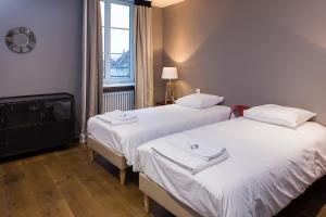 מיטה או מיטות בחדר ב-Le Comptoir du Voyageur