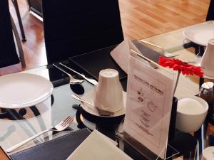 a glass table with utensils on top of it at Beechwood Ensuite Guest House in Ayr