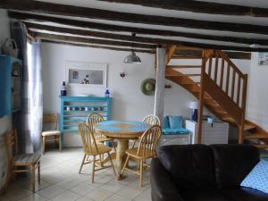 a dining room with a table and chairs at Gites de la Motte Parent in Plouguenast Langast