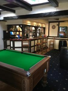 a pool table in a room with a bar at The Buck Inn in Richmond