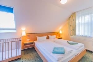 Säng eller sängar i ett rum på Am Weststrand Apartmenthaus Waldeck