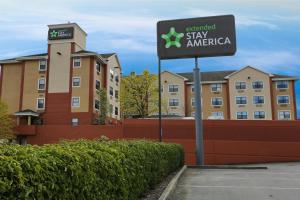 a sign in a parking lot in front of a building at Extended Stay America Suites - Tacoma - South in Tacoma