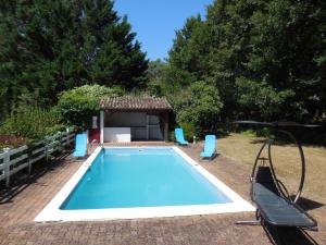 a swimming pool with a gazebo next to at Le Clos des Archers in Laveyssière
