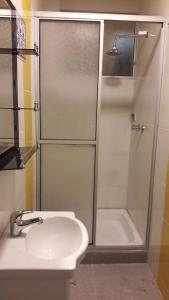 a bathroom with a shower and a sink and a tub at Apart Serma Hotel in Potosí +29 photos