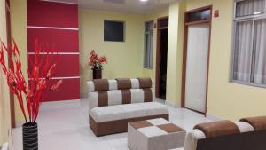 a living room with a couch and a chair at Apart Serma Hotel in Potosí