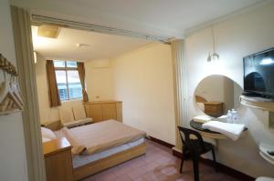 Letto o letti in una camera di Yi Yuan Hotel
