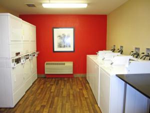 a bathroom with sinks and a red wall at Extended Stay America Suites - San Jose - Edenvale - North in Coyote +48 photos