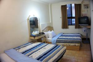 Letto o letti in una camera di Yi Yuan Hotel