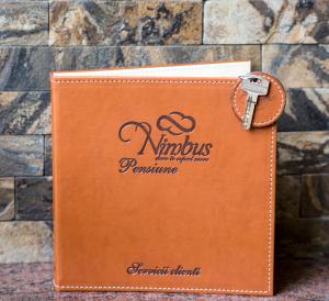 a brown leather wallet with a key on top at Pensiunea Nimbus in Arad +30 photos