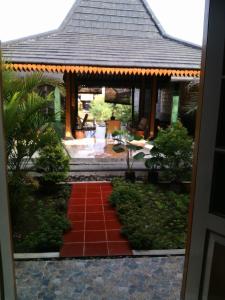 a red tiled path in front of a house at Rakai Garung in Yogyakarta +15 photos