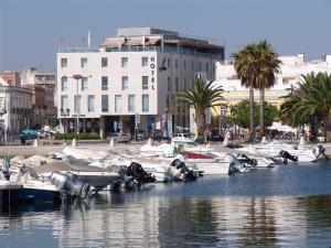 a group of boats are docked in a harbor at Hotel Faro & Beach Club in Faro