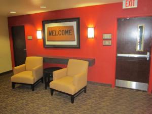 a waiting room with two chairs and a welcome sign at Extended Stay America Suites - Orange County - John Wayne Airport in Newport Beach