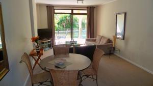 a living room with a table and chairs at La Savina - The Island Club in Cape Town