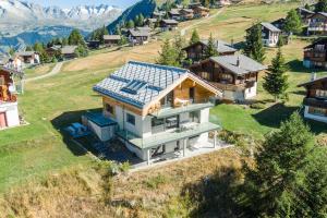 an aerial view of a house with a solar roof at Chalet Avista in Rosswald