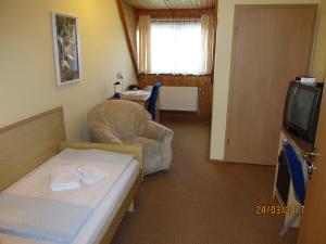 A bed or beds in a room at Hotel Landhaus Nassau