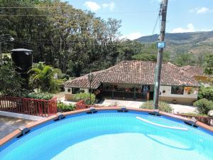 a swimming pool in front of a house at Finca Sol y Luna in San Gil