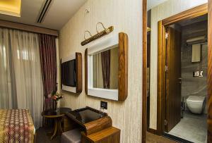 a bathroom with a bed and a sink and a mirror at Vertu istanbul in Istanbul +29 photos