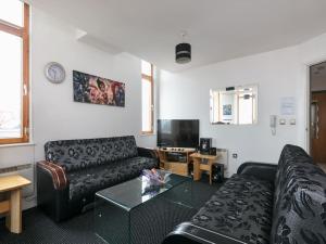 a living room with a couch and a table at My-Places Central Apartments in Manchester