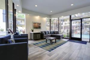 a lobby with couches and a table and windows at GreenTree Pasadena in Pasadena