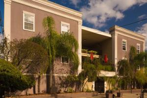 a building with trees in front of it at Frenchmen Orleans at 519, Ascend Hotel Collection in New Orleans