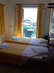 Postel nebo postele na pokoji v ubytování Kythereia Hotel