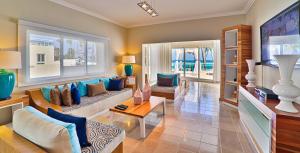 a living room with a couch and a table at Bavaro Hotel Cortecito in Punta Cana