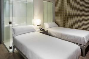 Postel nebo postele na pokoji v ubytování Hotel Atalaia