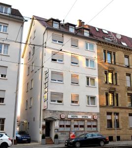 a building with a car parked in front of it at Hotel Stern in Stuttgart