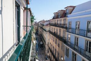 a view of a city street from a balcony at Cosy Baixa Apartment in Lisbon