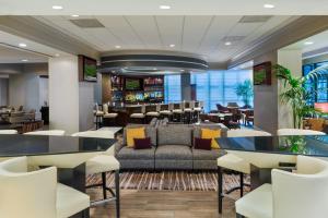 a lobby with a couch and a bar at Chicago Marriott Suites Deerfield in Deerfield