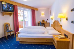 Postel nebo postele na pokoji v ubytování Hotel Piccolo