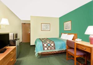 a hotel room with a bed and a desk and a television at Spark by Hilton Carlisle South in Carlisle