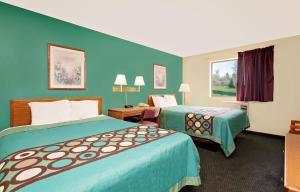 a hotel room with two beds and a window at Spark by Hilton Carlisle South in Carlisle