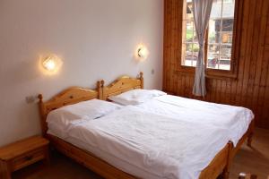 Letto o letti in una camera di Hôtel - Petit-déjeuner Le Trift