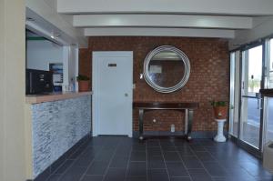 a room with a counter and a mirror on the wall at Americas Best Value Inn Augusta Downtown in Augusta