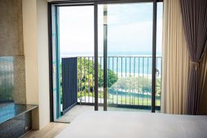 a bedroom with a large window with a view of the ocean at Kadda Hotel in Hualien City