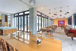 a large room with tables and chairs and windows at Kadda Hotel in Hualien City