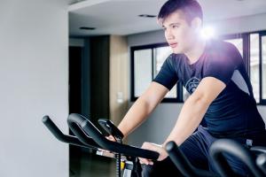 a man sitting on a bike in a gym at Kadda Hotel in Hualien City