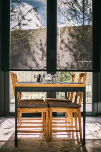 a wooden table and chairs in front of a window at Kadda Hotel in Hualien City