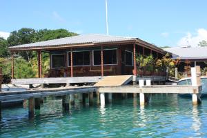 a house on a dock on the water at Utila Lodge in Utila