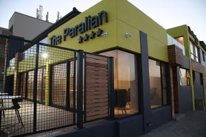 een restaurant met een bord aan de zijkant van een gebouw bij The Paralian Exclusive Guest House in East London